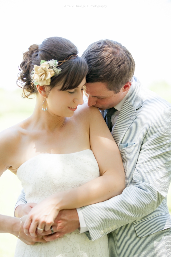 bride and groom kissing shoulder