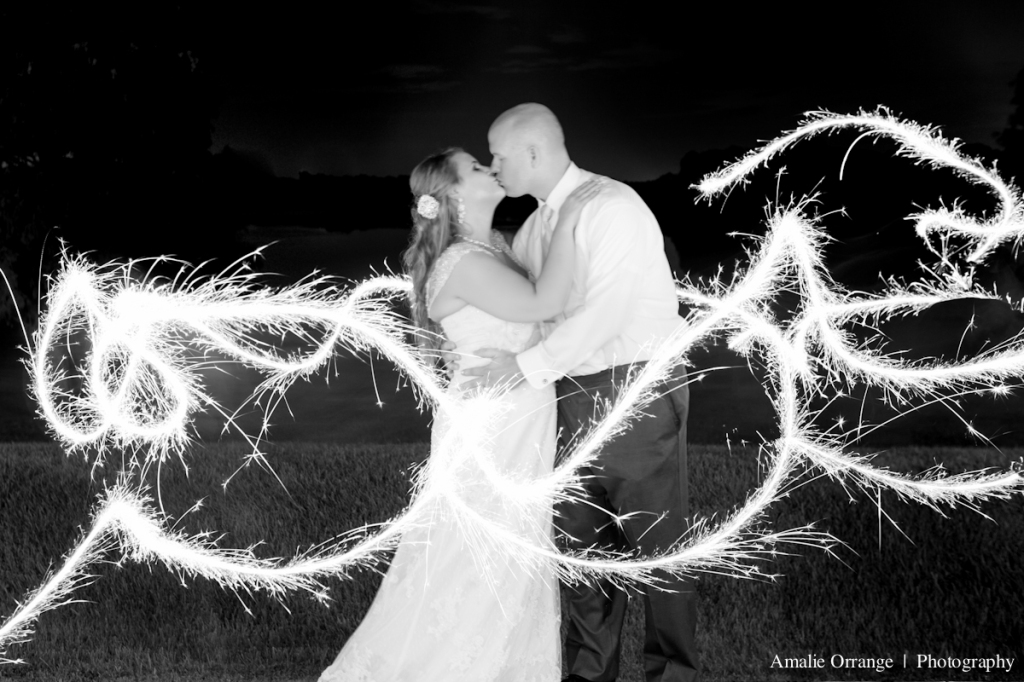 wedding photographer sparklers with bride and groom