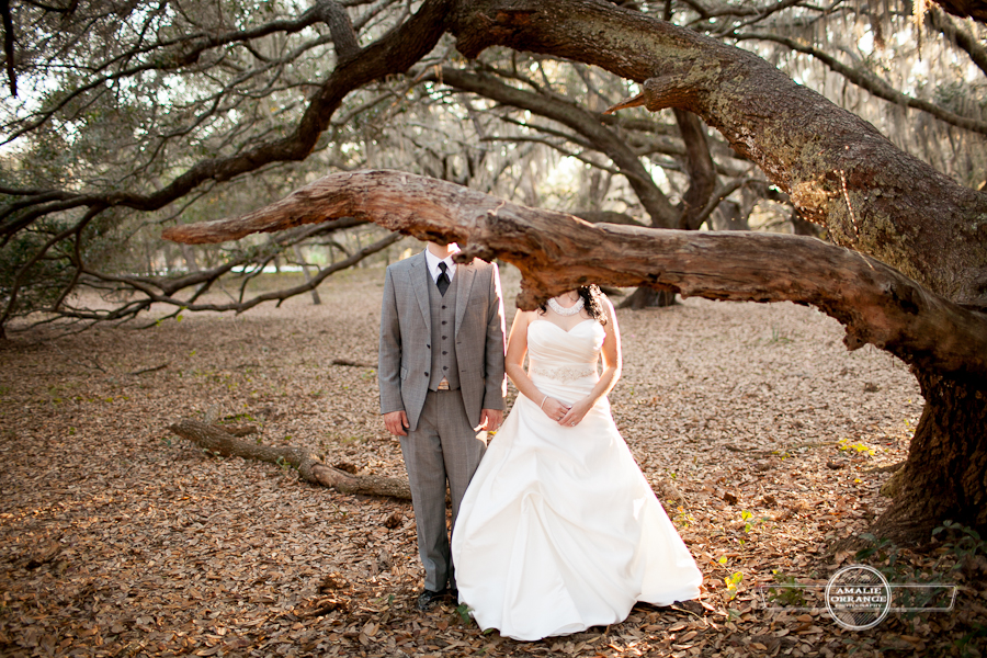 bride and groom behind tree